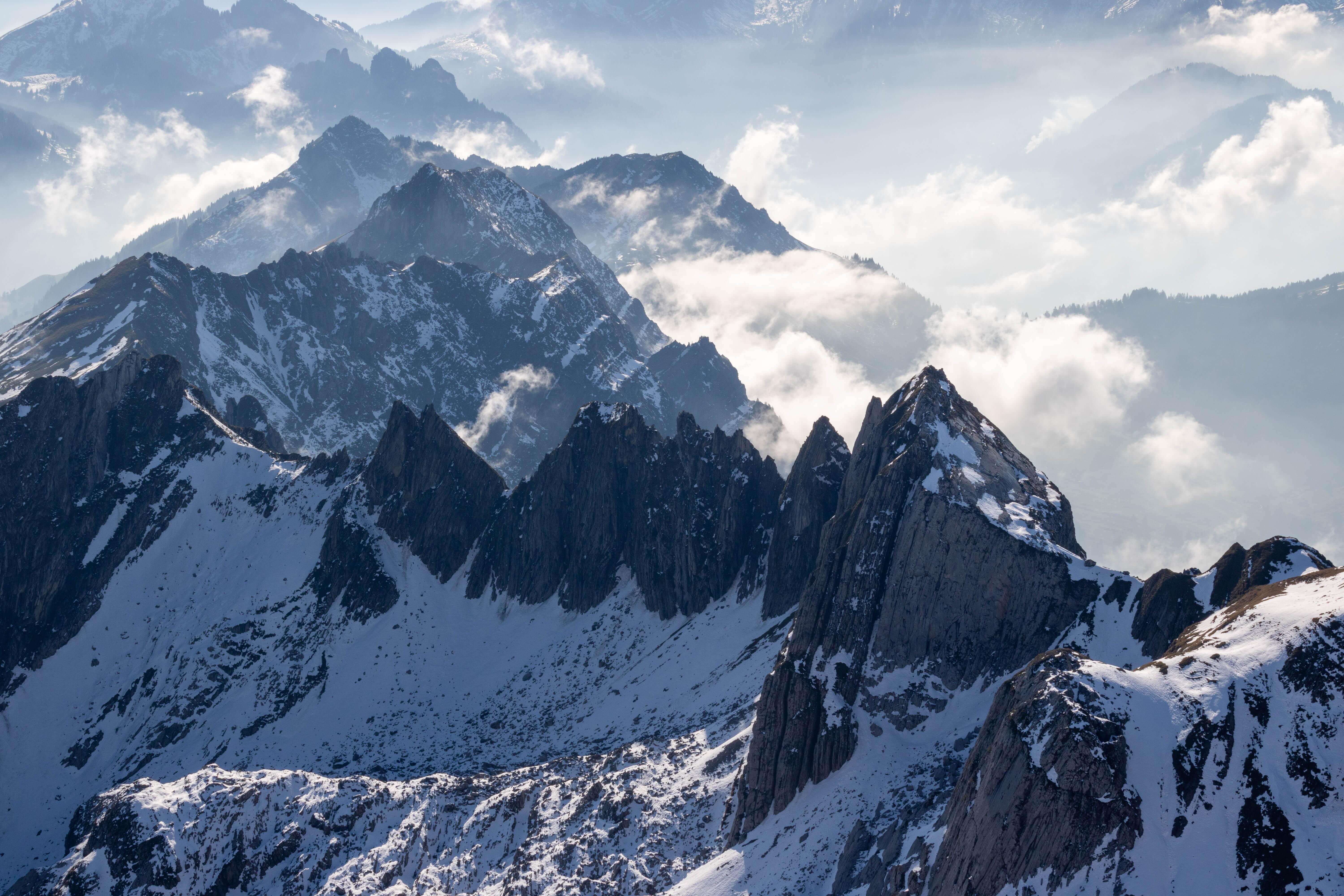 Rugged snow-covered Himalayan ridgeline under a clearing sky